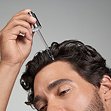 Applying K18 Future IQ serum to hair